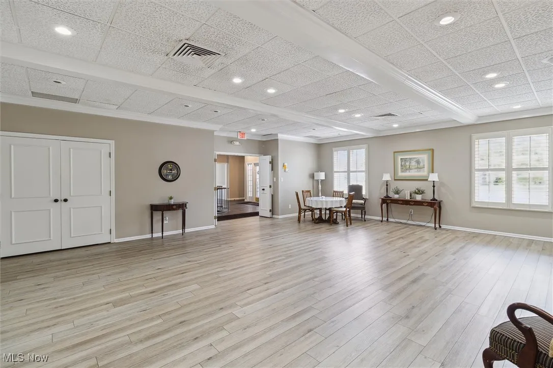 Sitting room with light wood-style flooring and recessed lighting