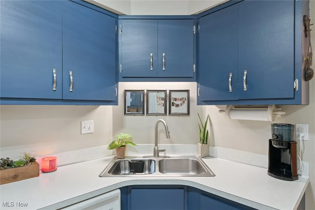 Kitchen featuring blue cabinetry and light countertops
