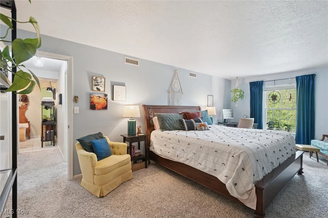 Bedroom with carpet flooring and a textured ceiling
