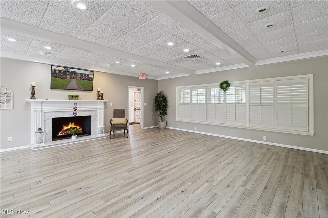 Unfurnished living room featuring a high end fireplace, recessed lighting, and light wood finished floors