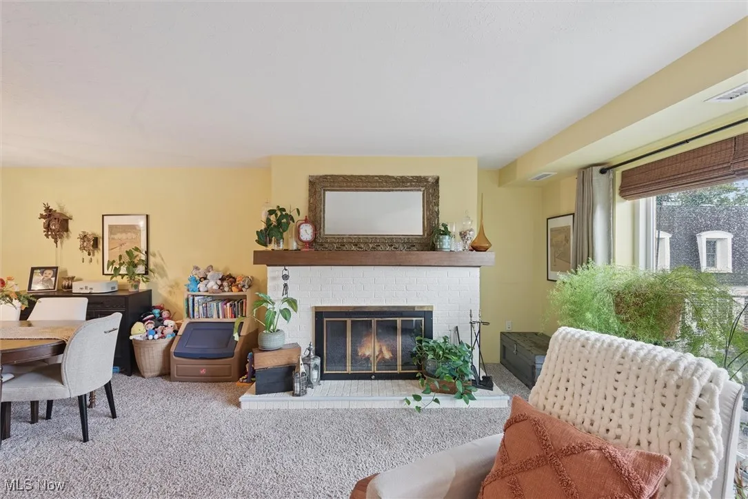 Living room featuring a fireplace and carpet