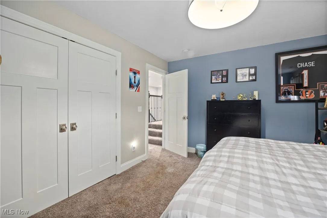 Carpeted bedroom with a closet and baseboards