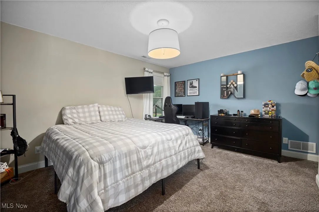 Carpeted bedroom with baseboards