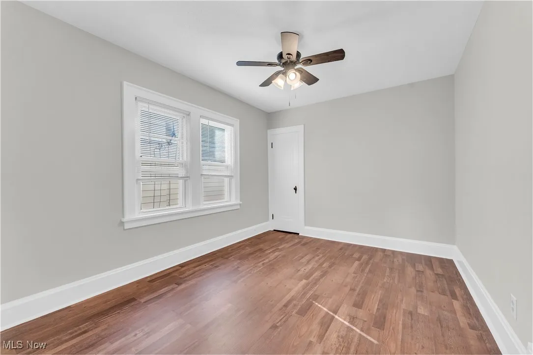 Unfurnished room featuring wood finished floors and a ceiling fan