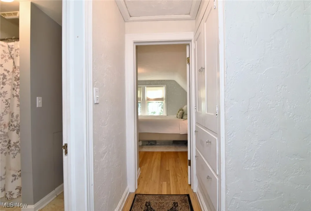 Upstairs Hall with a textured wall and light wood finished floors