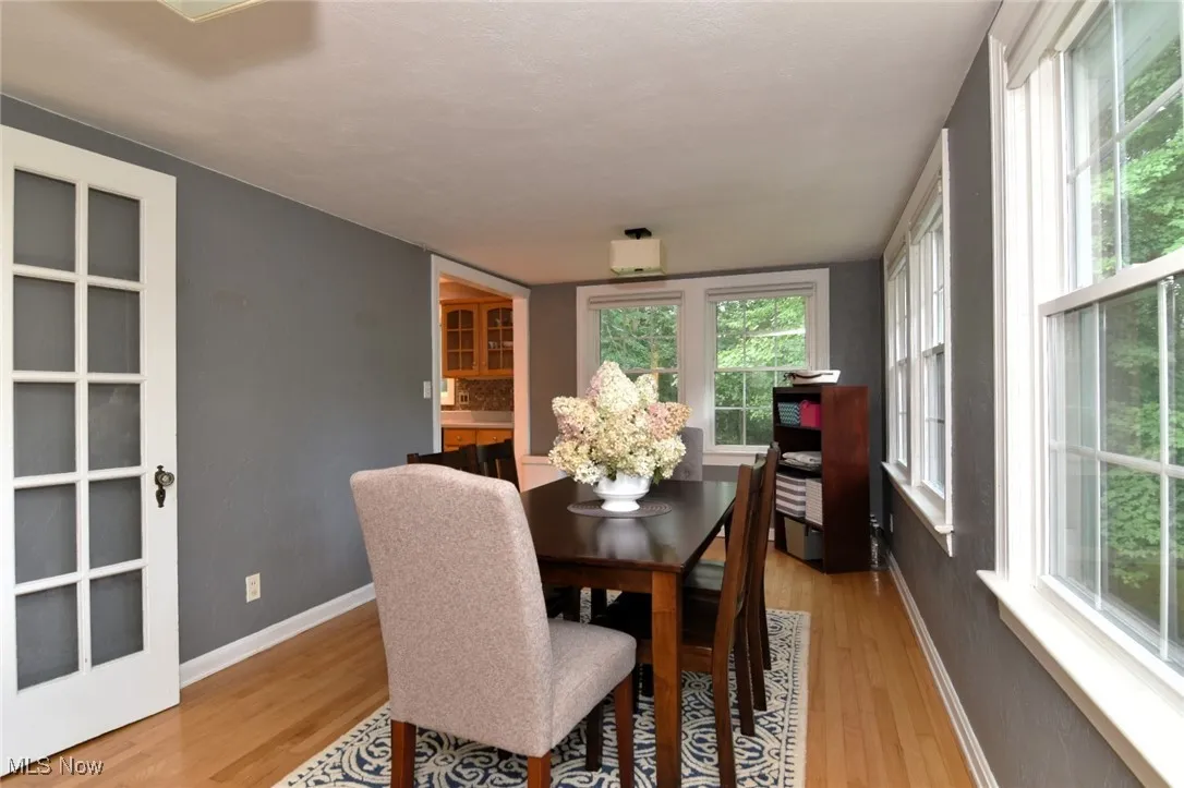 Dining area featuring light wood-style flooring and baseboards