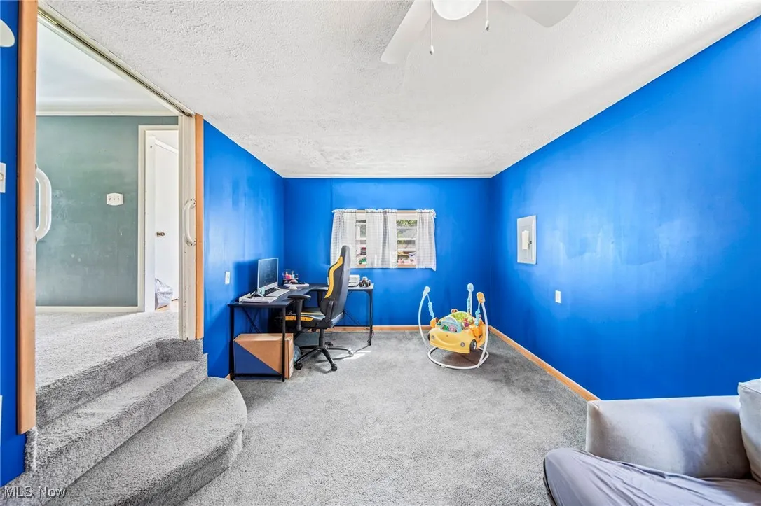 Office featuring carpet flooring, a textured ceiling, and a ceiling fan