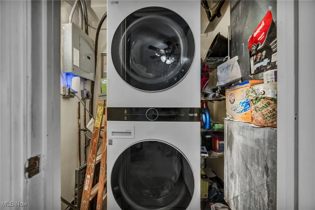 Washroom with stacked washer / drying machine and electric panel