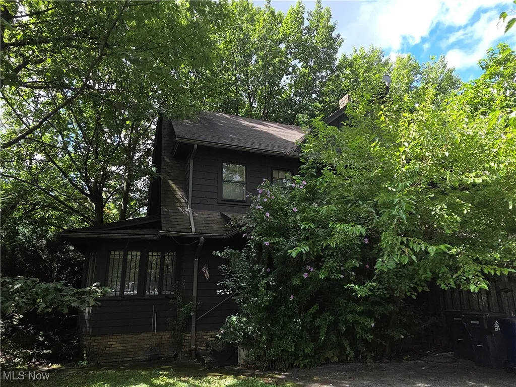 View of property exterior featuring roof with shingles