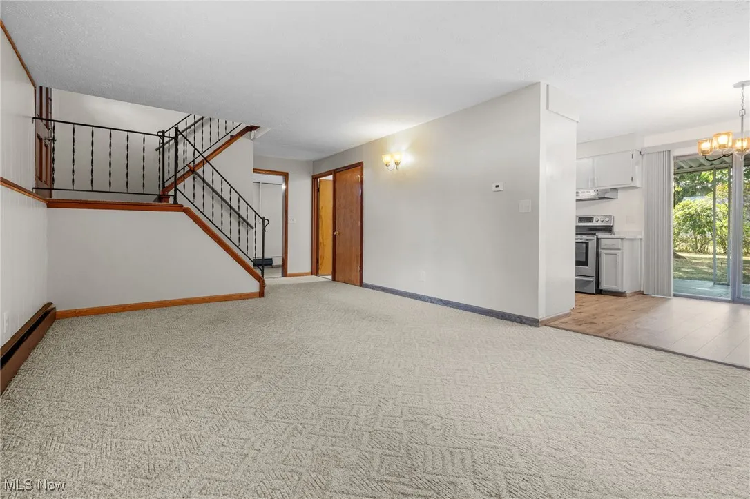 Stairway from front door leads down into the family room and open to the eat-in kitchen