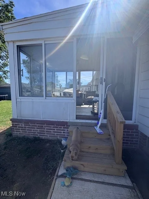Property entrance featuring a sunroom
