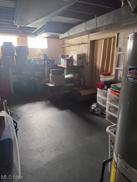 Below grade area featuring water heater