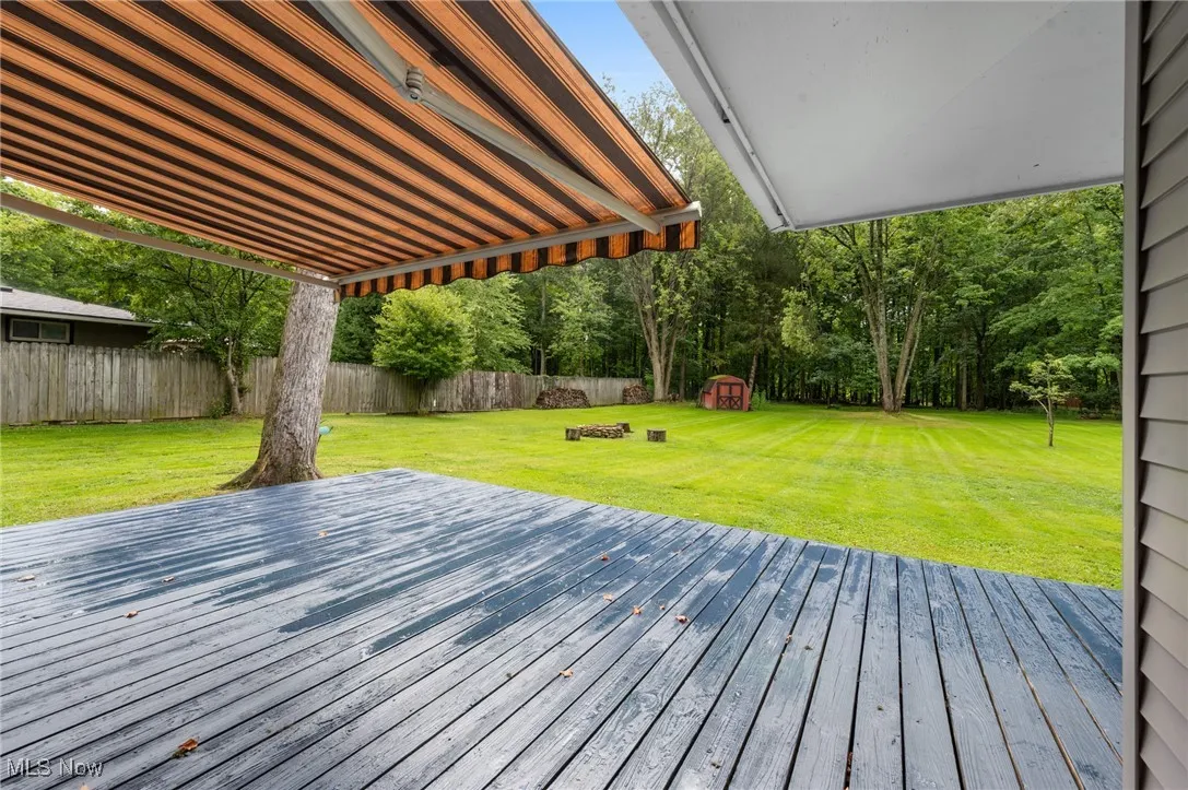 Wooden terrace featuring a storage unit