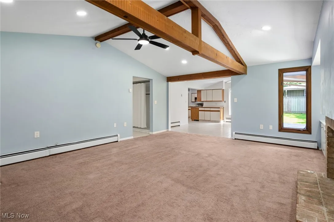 Unfurnished living room with recessed lighting, light carpet, baseboard heating, a ceiling fan, and a baseboard radiator
