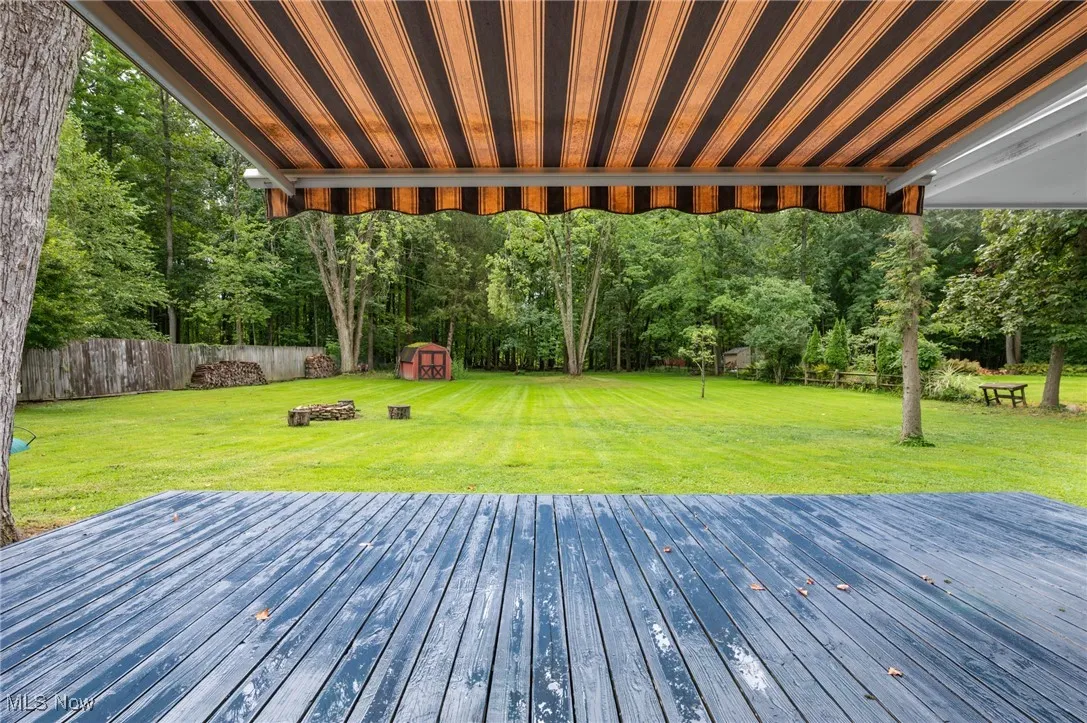 Wooden terrace featuring a shed