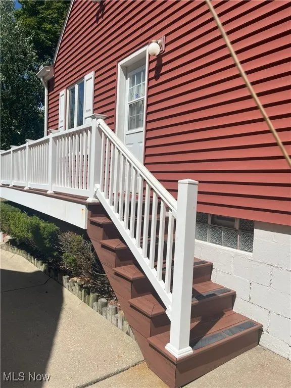View of exterior entry with a deck