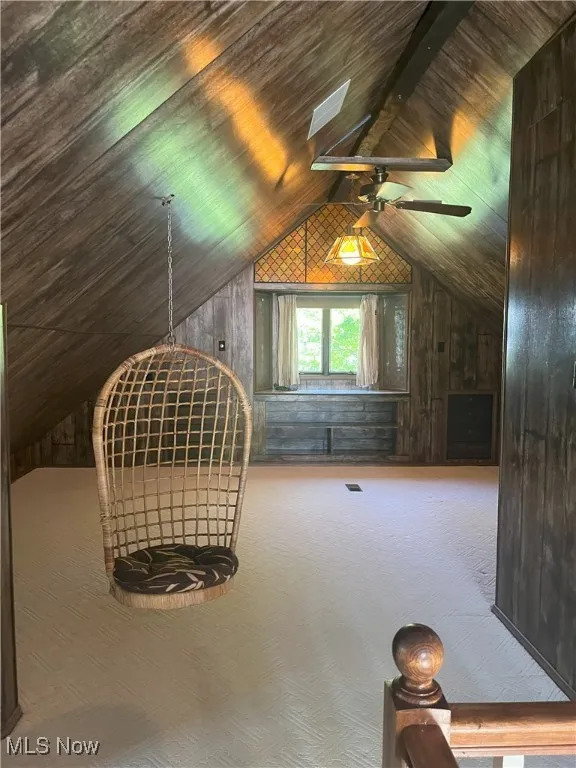Bonus room with wooden walls, carpet floors, and wooden ceiling