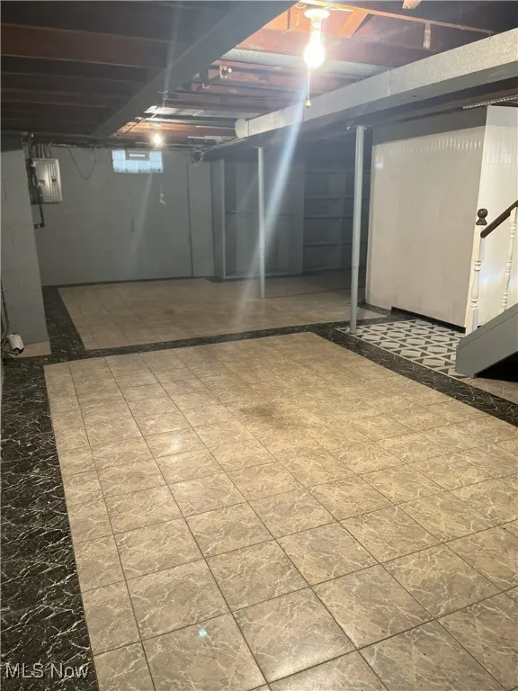 Unfinished below grade area with electric panel
