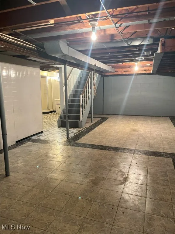 Unfinished basement featuring stairway