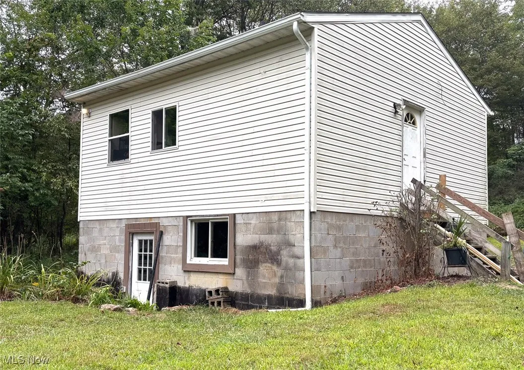 View of side of property with a lawn