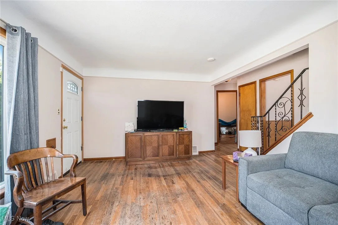 Living area featuring hardwood / wood-style flooring and stairway