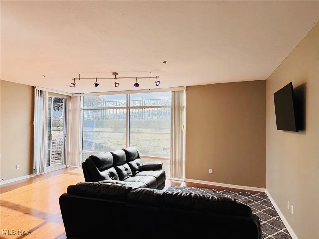 Living room featuring baseboards and floor to ceiling windows