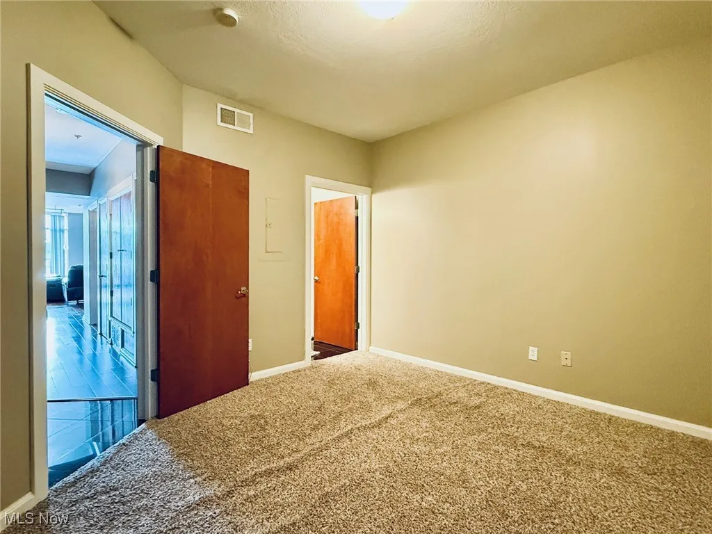 Unfurnished bedroom with baseboards and carpet flooring