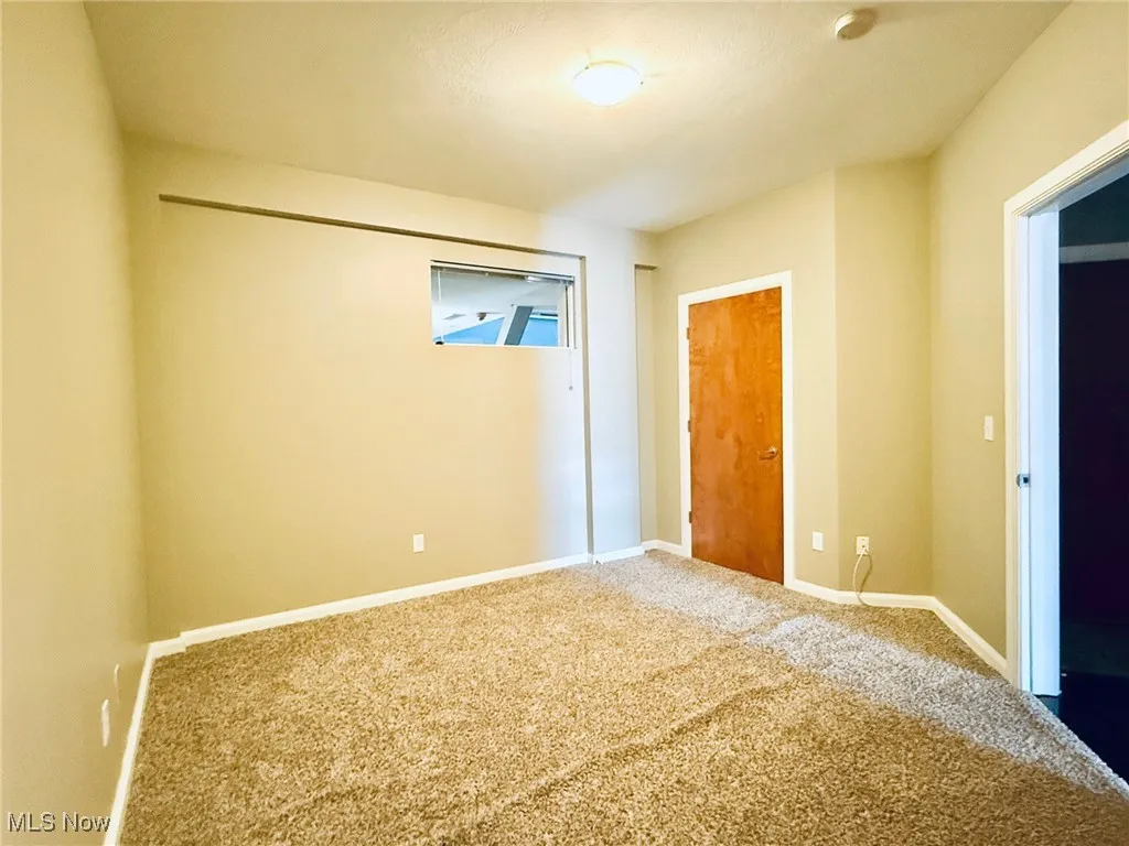 Spare room with carpet flooring and baseboards