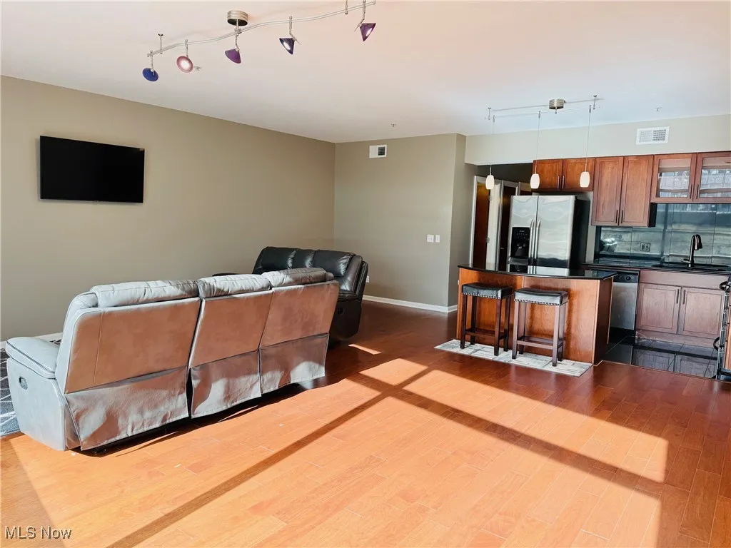 Living room featuring track lighting and dark wood-type flooring