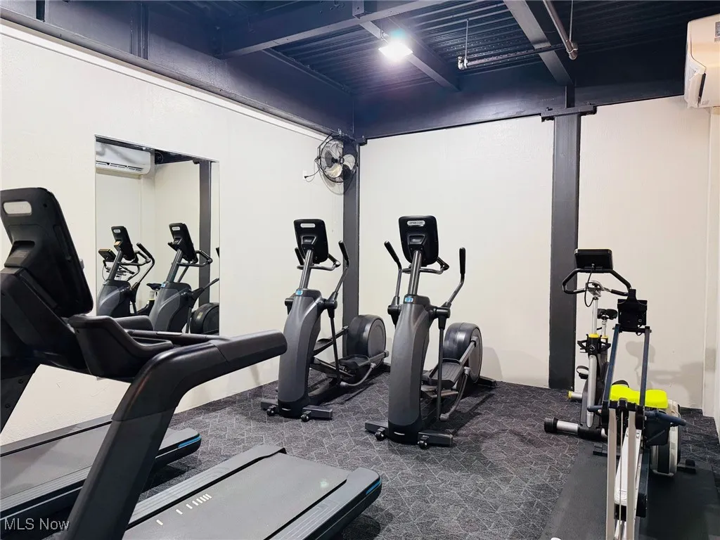 Exercise room featuring a wall unit AC and a wall mounted air conditioner