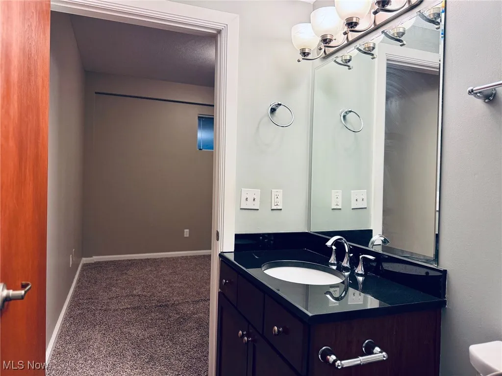 Bathroom with vanity and baseboards