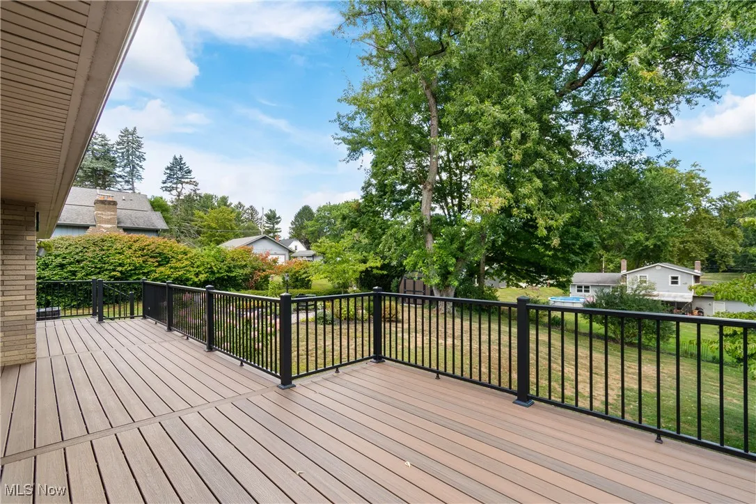 Composite deck featuring view of wooded area