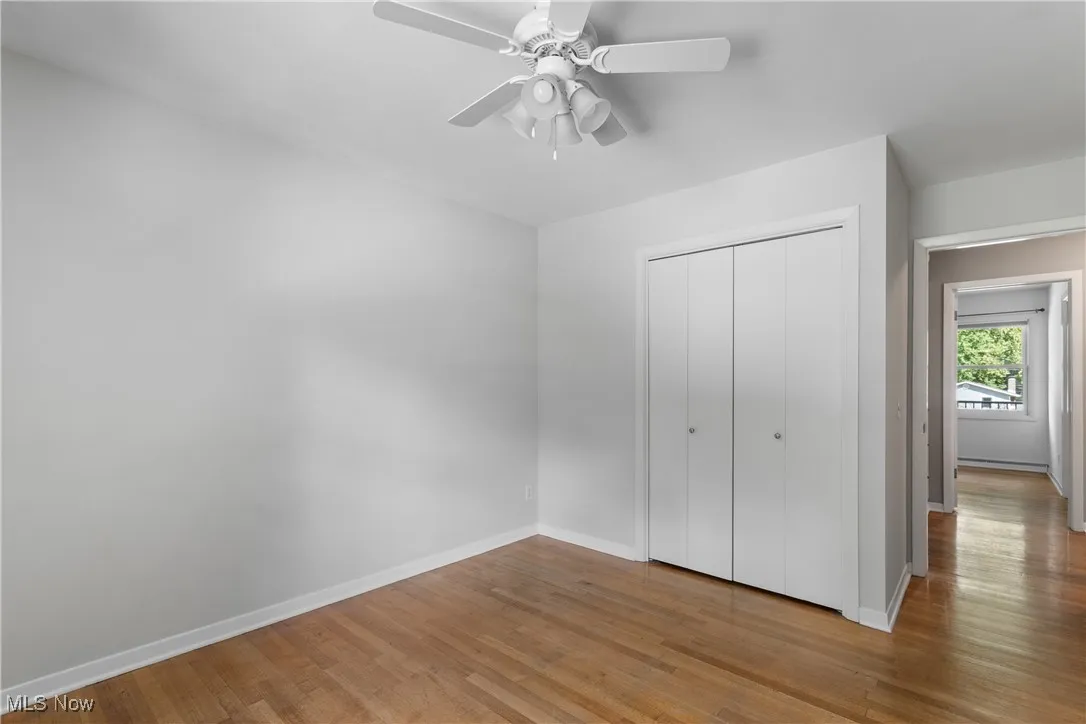 bedroom 4 Unfurnished bedroom featuring wood finished floors, a closet, and ceiling fan