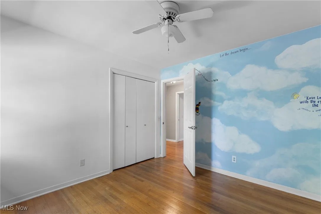 bedroom 3 Unfurnished bedroom featuring wood-type flooring, a closet, and ceiling fan