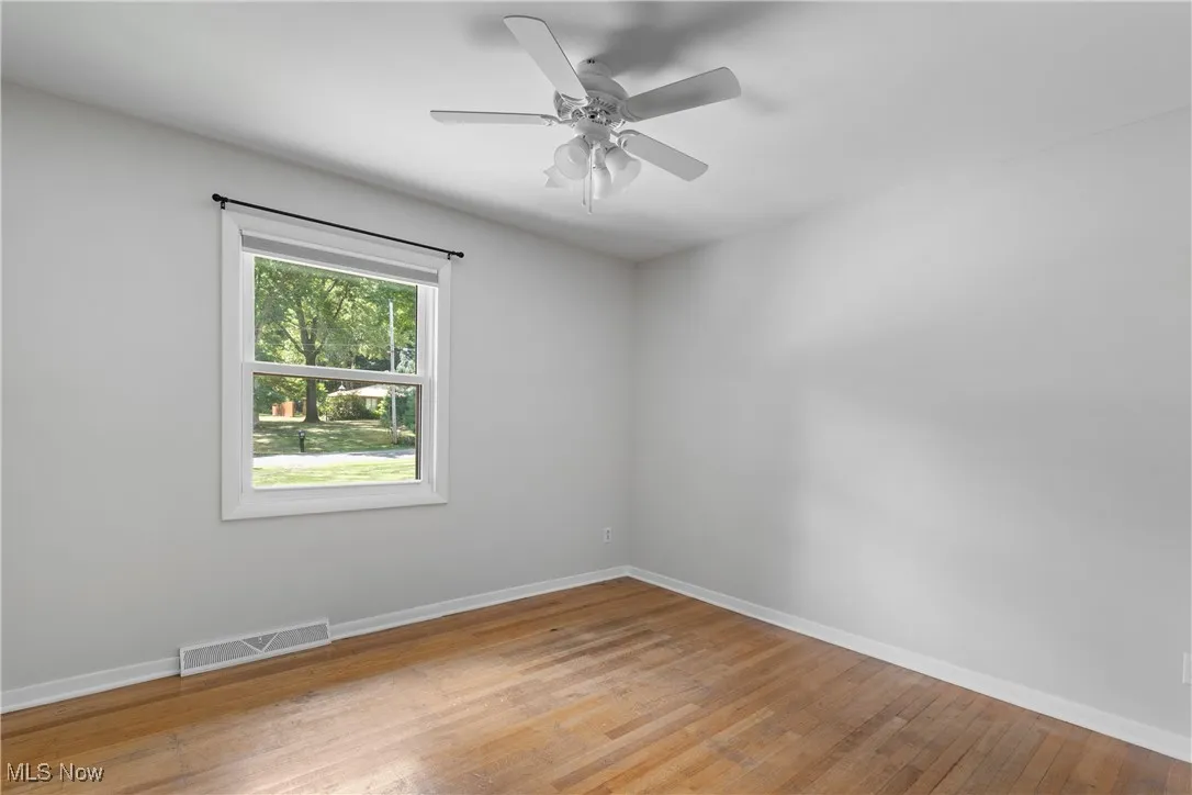 bedroom 4 Unfurnished room featuring light wood-style flooring and a ceiling fan