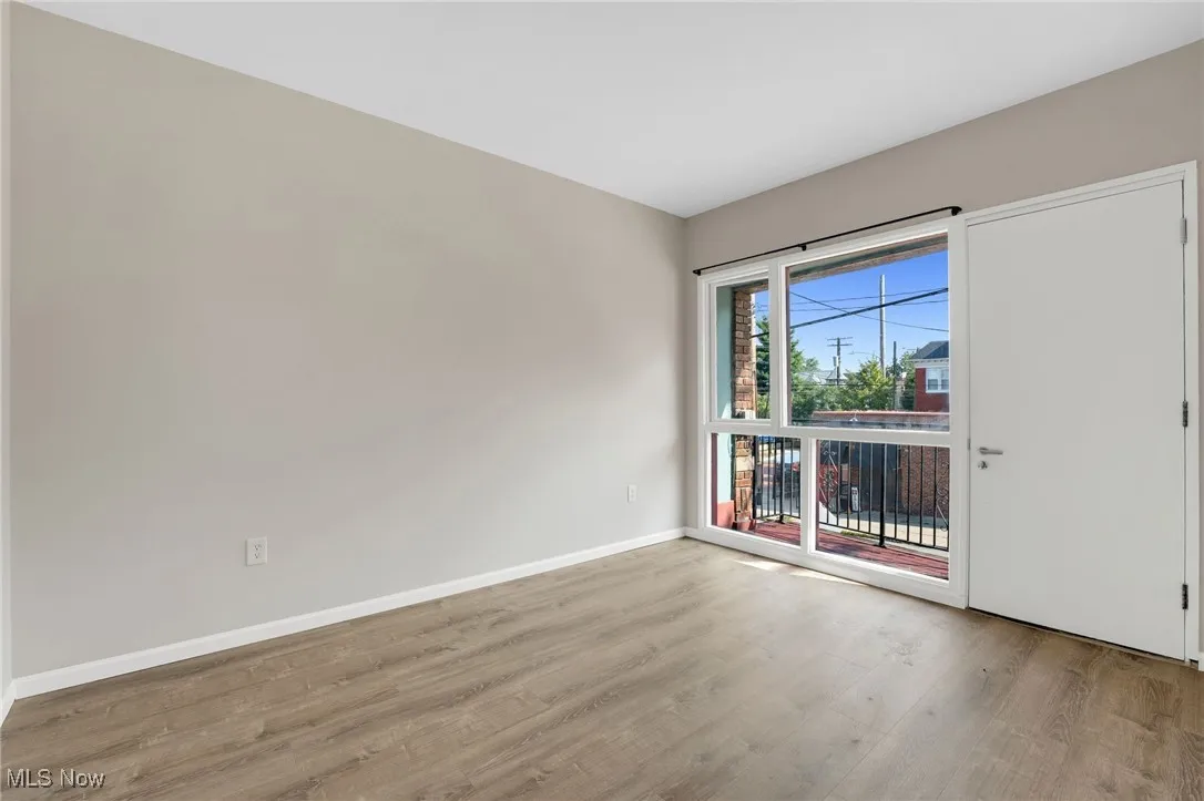 Empty room with light wood-style floors and baseboards