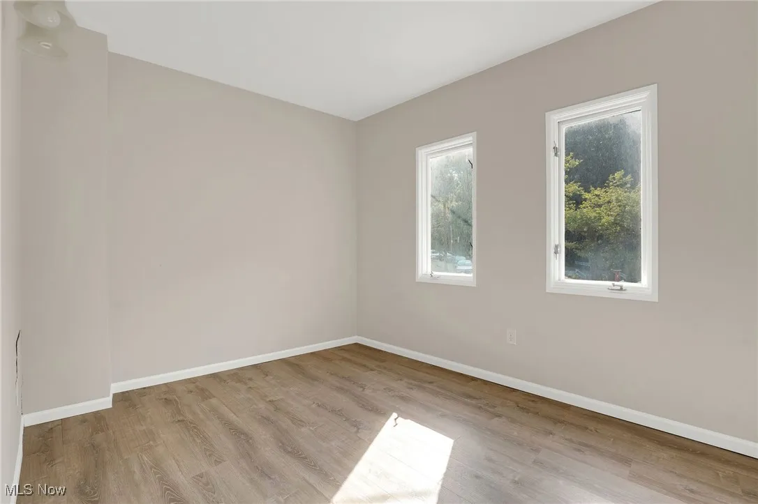 Unfurnished room featuring baseboards and light wood-style floors