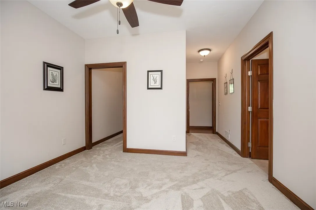 Unfurnished bedroom featuring light colored carpet and a ceiling fan