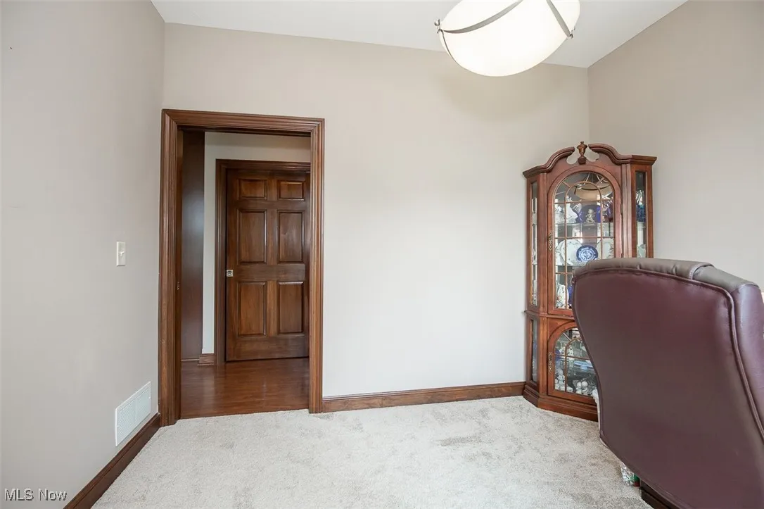 Home office with carpet and baseboards