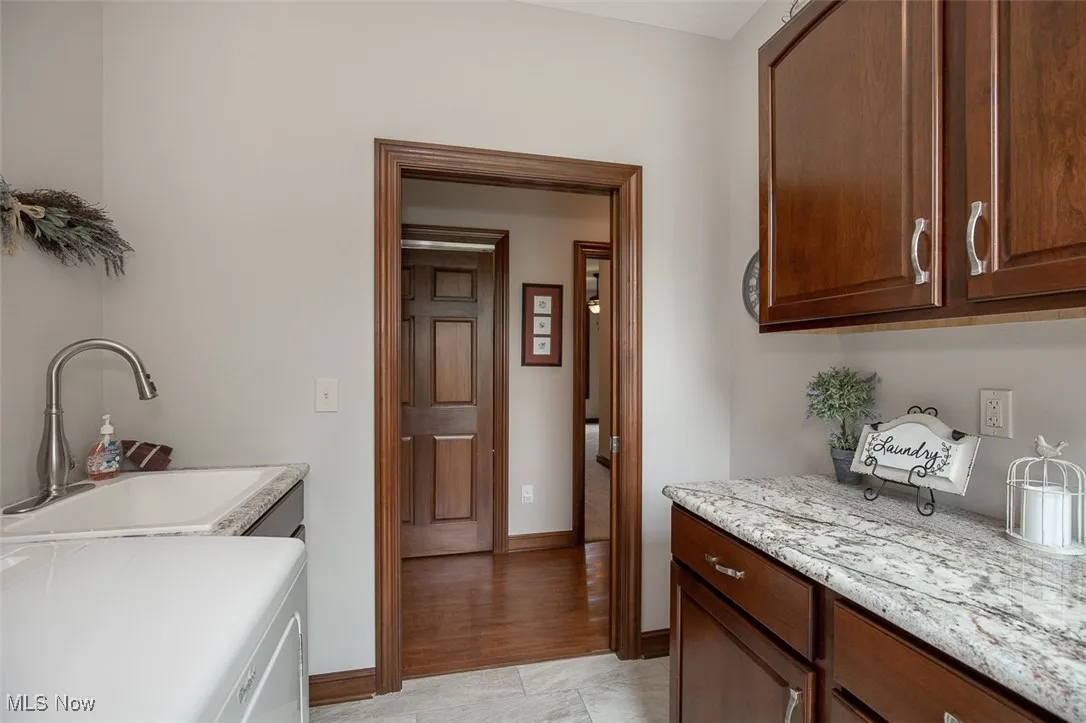 Laundry room featuring washer / clothes dryer and cabinet space