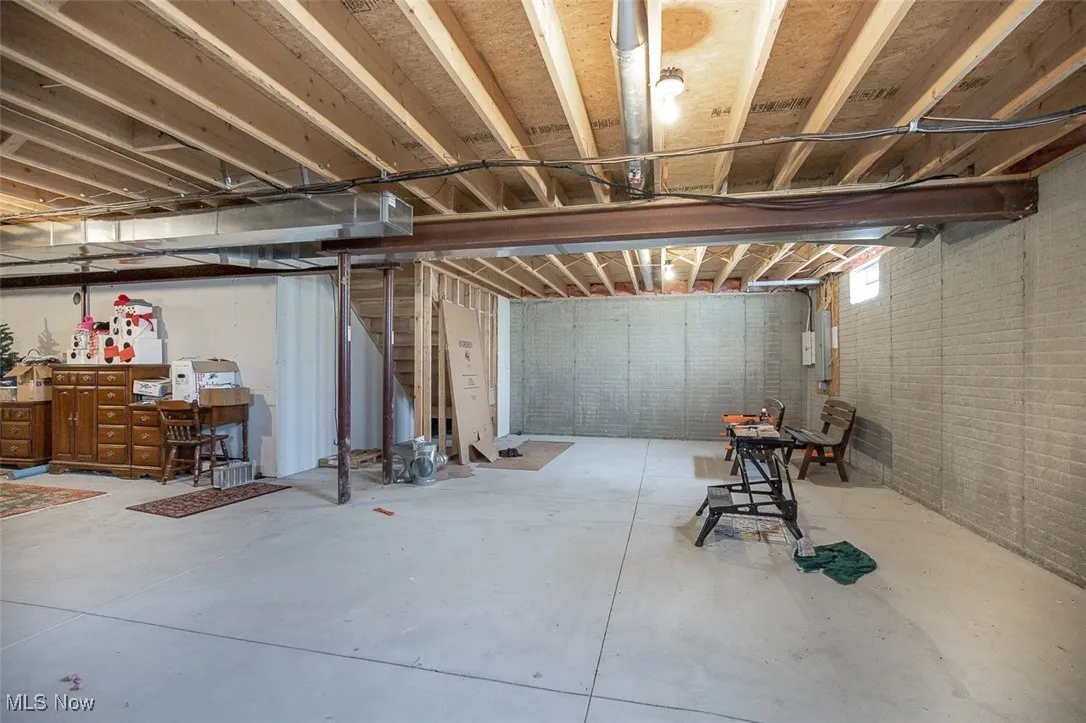 Unfinished basement featuring stairway