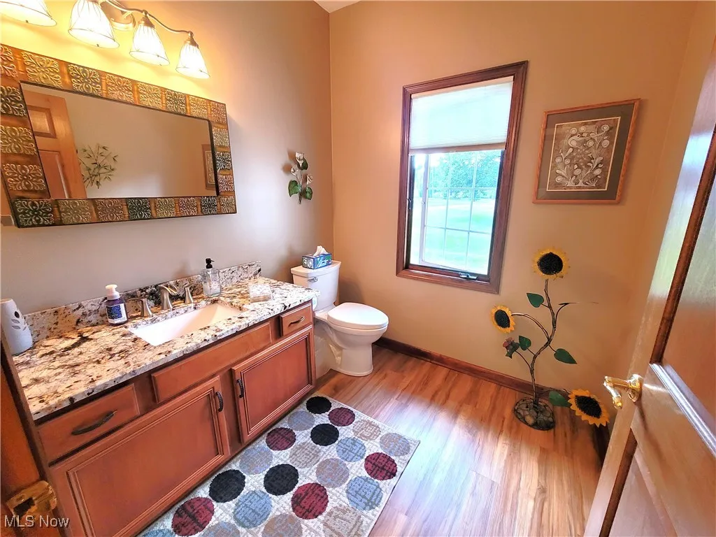 Bathroom with light wood-style flooring and vanity