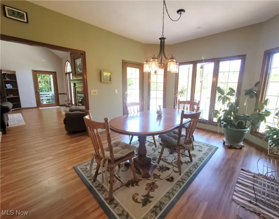 Dining area with light wood-style flooring and a chandelier