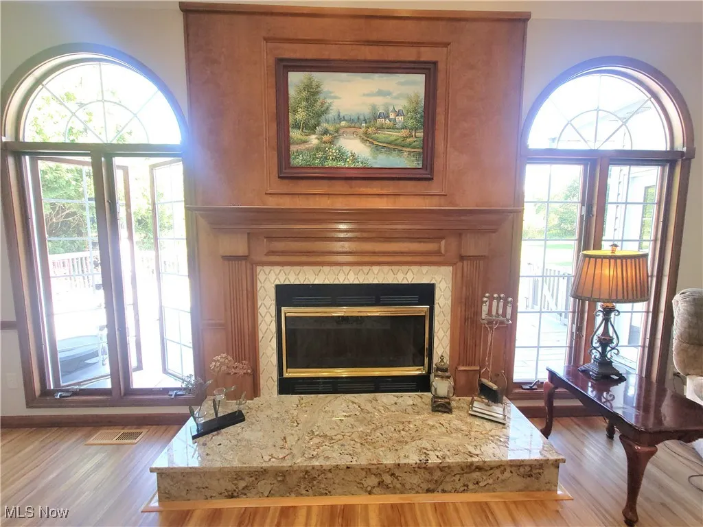 Detailed view of a fireplace and wood finished floors