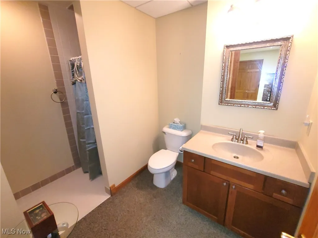 Full bathroom with tiled shower and vanity