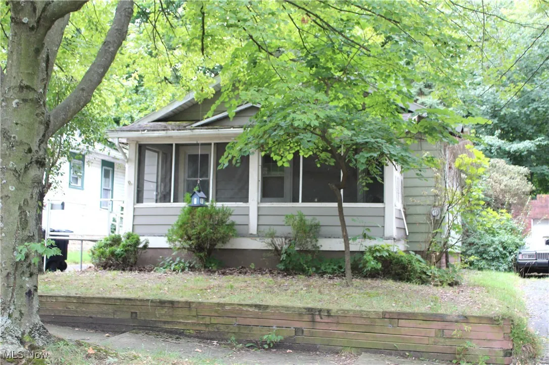 View of front of house with a sunroom