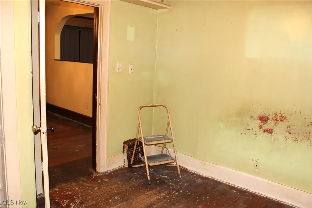 Primary bedroom featuring dark wood-style floors and baseboards