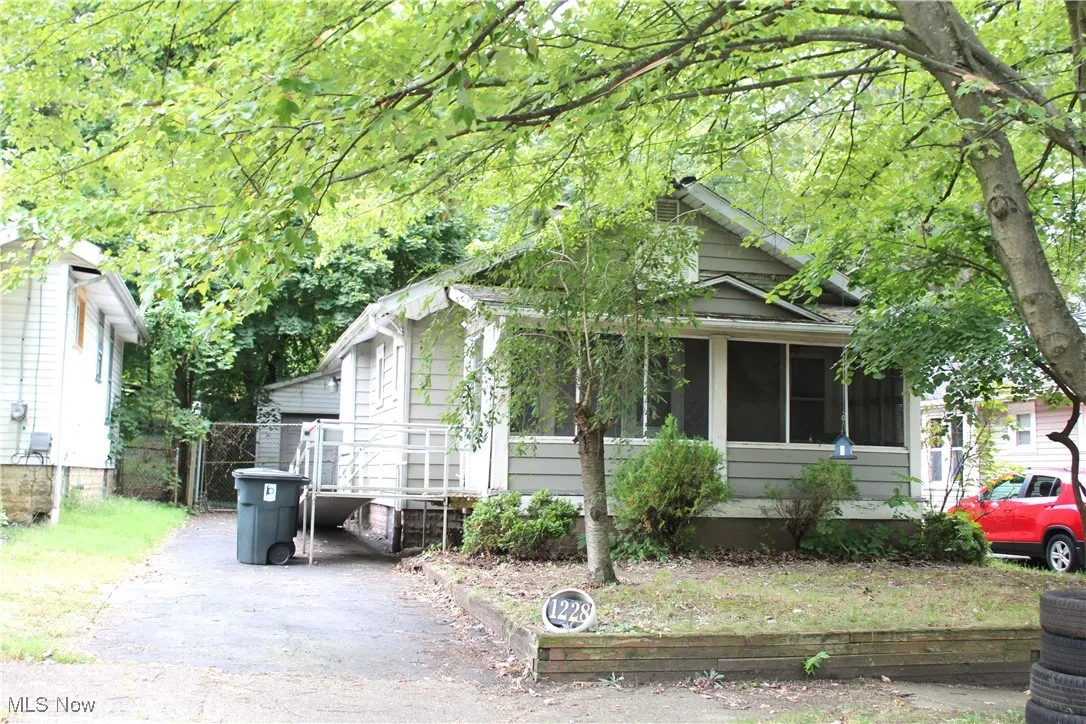 View of front of property featuring a sunroom