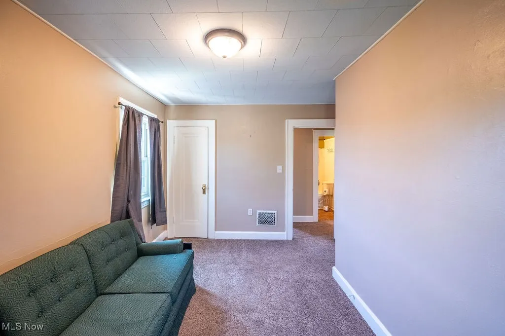 Living area with carpet flooring and baseboards