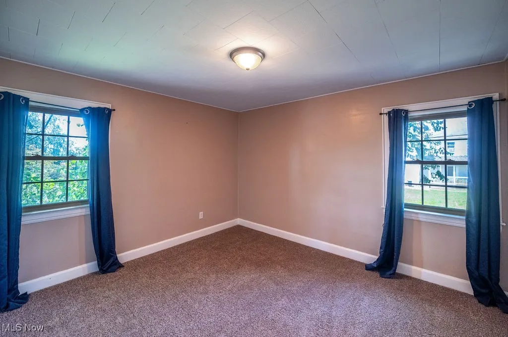 Spare room with dark carpet